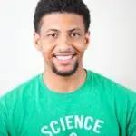 Portrait of a smiling young man wearing a green T-shirt with science text.